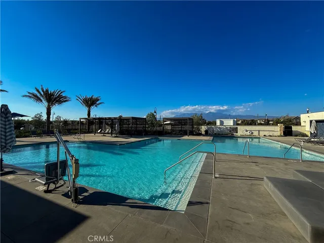 a view of a swimming pool with a yard