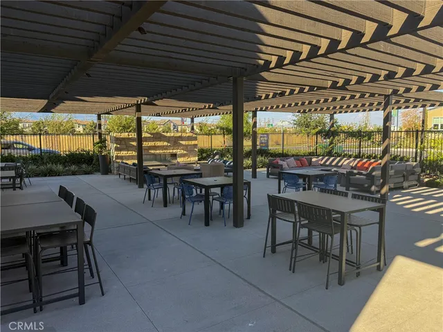 a patio with a table and chairs