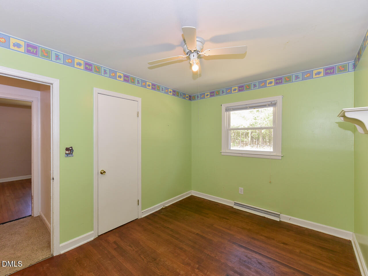 1703 St Patrick Drive Raleigh, NC 27603 - Photo 16 of 29 a view of an empty room with wooden floor and a window