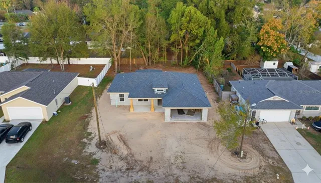 an aerial view of a house with a yard