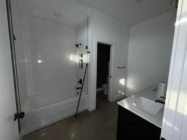 a view of a livingroom with a ceiling fan and window