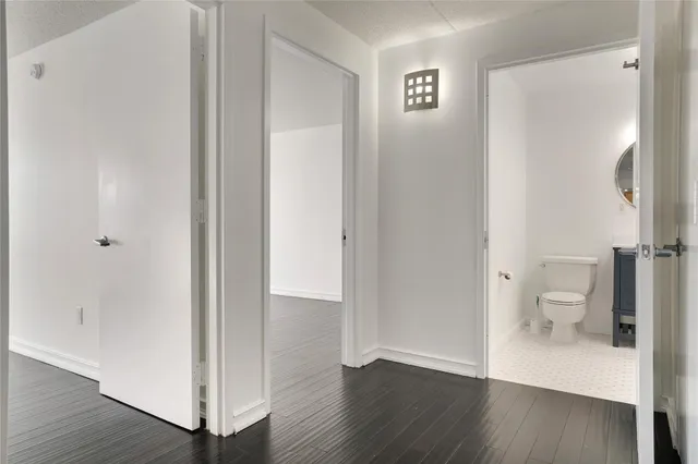 an empty room with wooden floor and a window