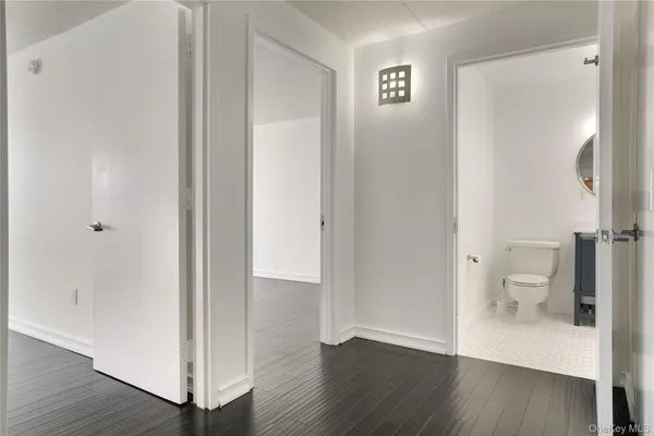 an empty room with wooden floor and a window