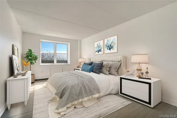 a bedroom with a bed wooden floor and window
