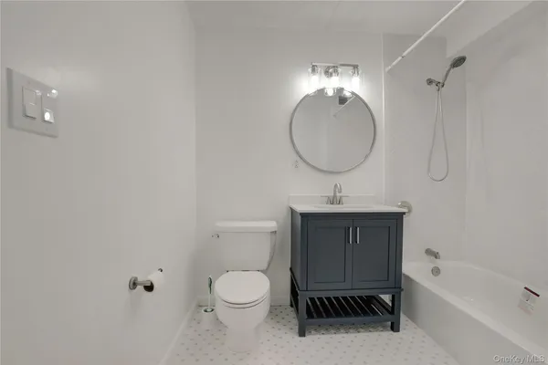 a bathroom with a toilet a sink a bathtub and vanity