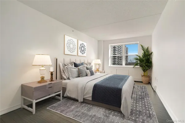 a bedroom with a bed and a night stand