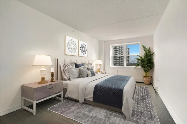 a bedroom with a bed and a night stand