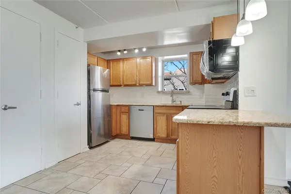 a kitchen with stainless steel appliances granite countertop a sink and cabinets
