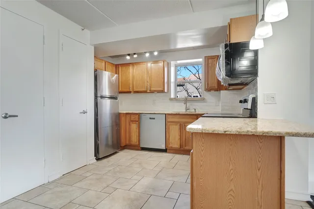 a kitchen with stainless steel appliances granite countertop a sink and cabinets
