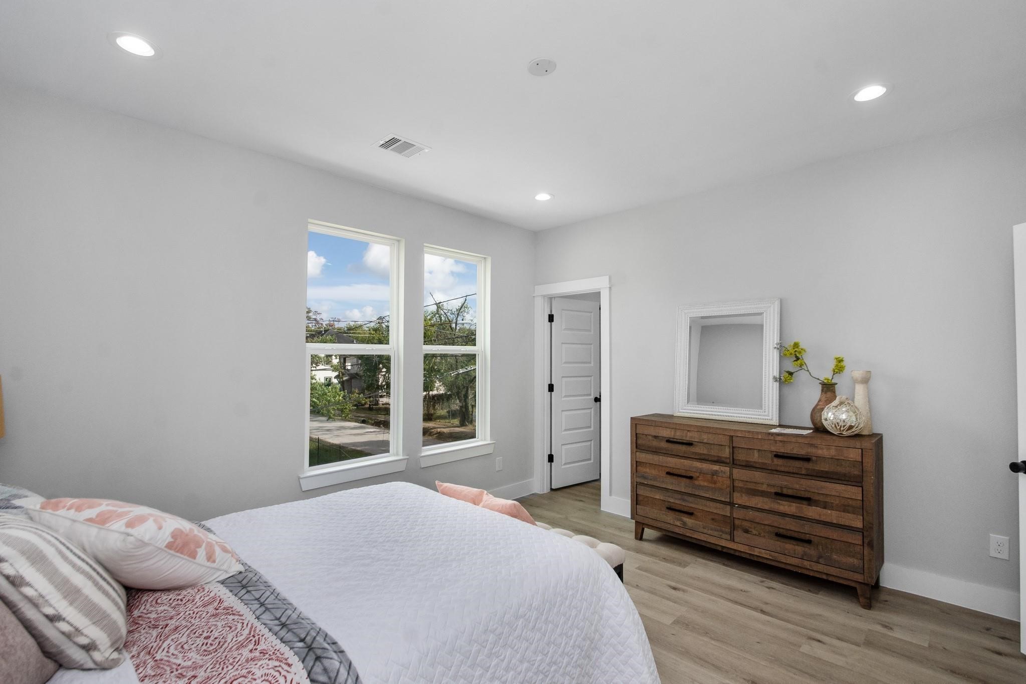 2105 Sam Wilson Street, Unit A Houston, TX 77020 - Photo 11 of 20 a bedroom with a bed and with windows