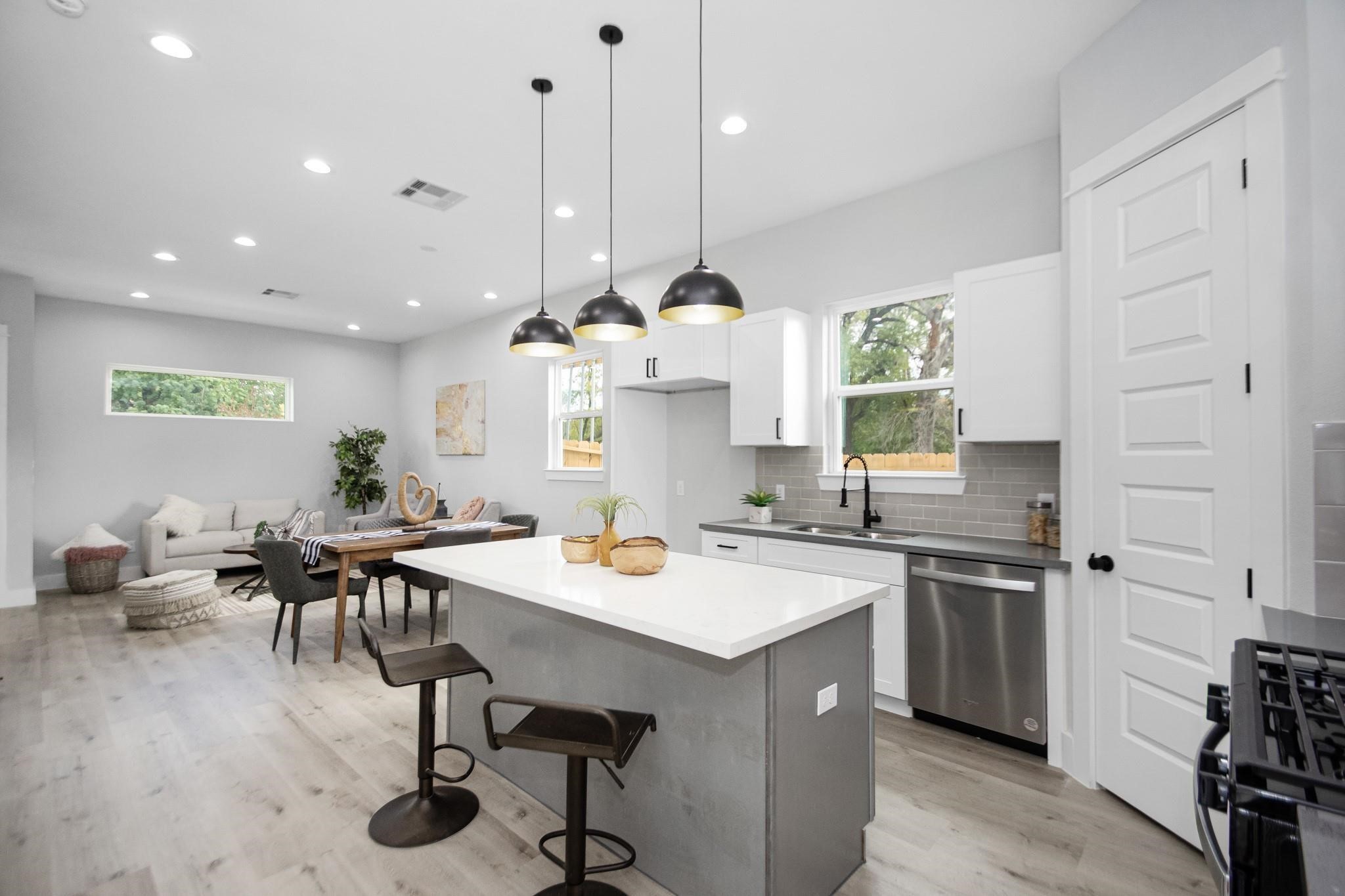 2105 Sam Wilson Street, Unit A Houston, TX 77020 - Photo 5 of 20 a kitchen with a table chairs sink and cabinets