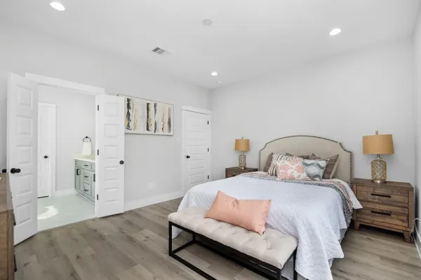a bedroom with a bed and wooden floor
