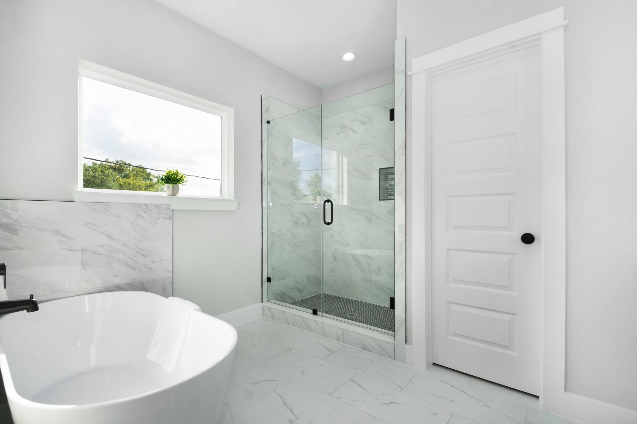2105 Sam Wilson Street, Unit A Houston, TX 77020 - Photo 8 of 20 a bathroom with a bathtub and shower