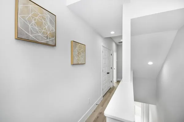 a view of a hallway with paintings on the wall