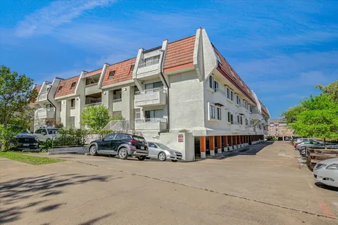 a view of a building with a swimming pool and sitting area