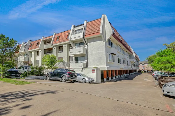 a view of a building with a swimming pool and sitting area