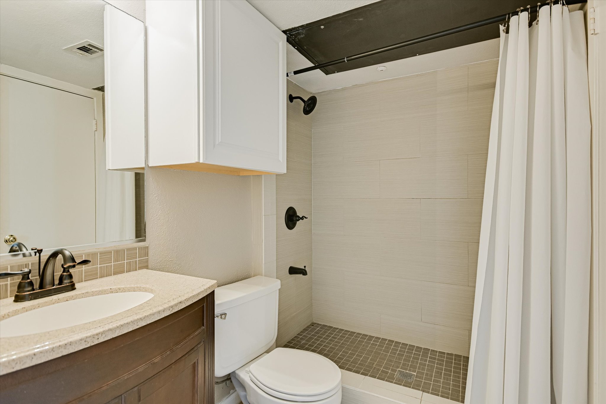 3115 Helms Street, Unit 112 Austin, TX 78705 - Photo 11 of 13 a bathroom with a sink toilet and shower
