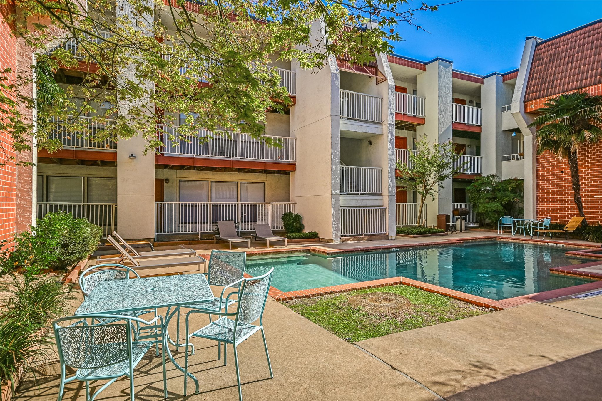 3115 Helms Street, Unit 112 Austin, TX 78705 - Photo 13 of 13 a view of a house with swimming pool and sitting area
