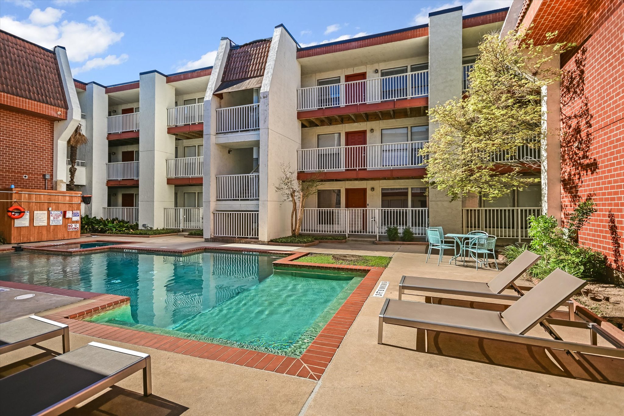 3115 Helms Street, Unit 112 Austin, TX 78705 - Photo 2 of 13 a view of a building with a swimming pool and sitting area