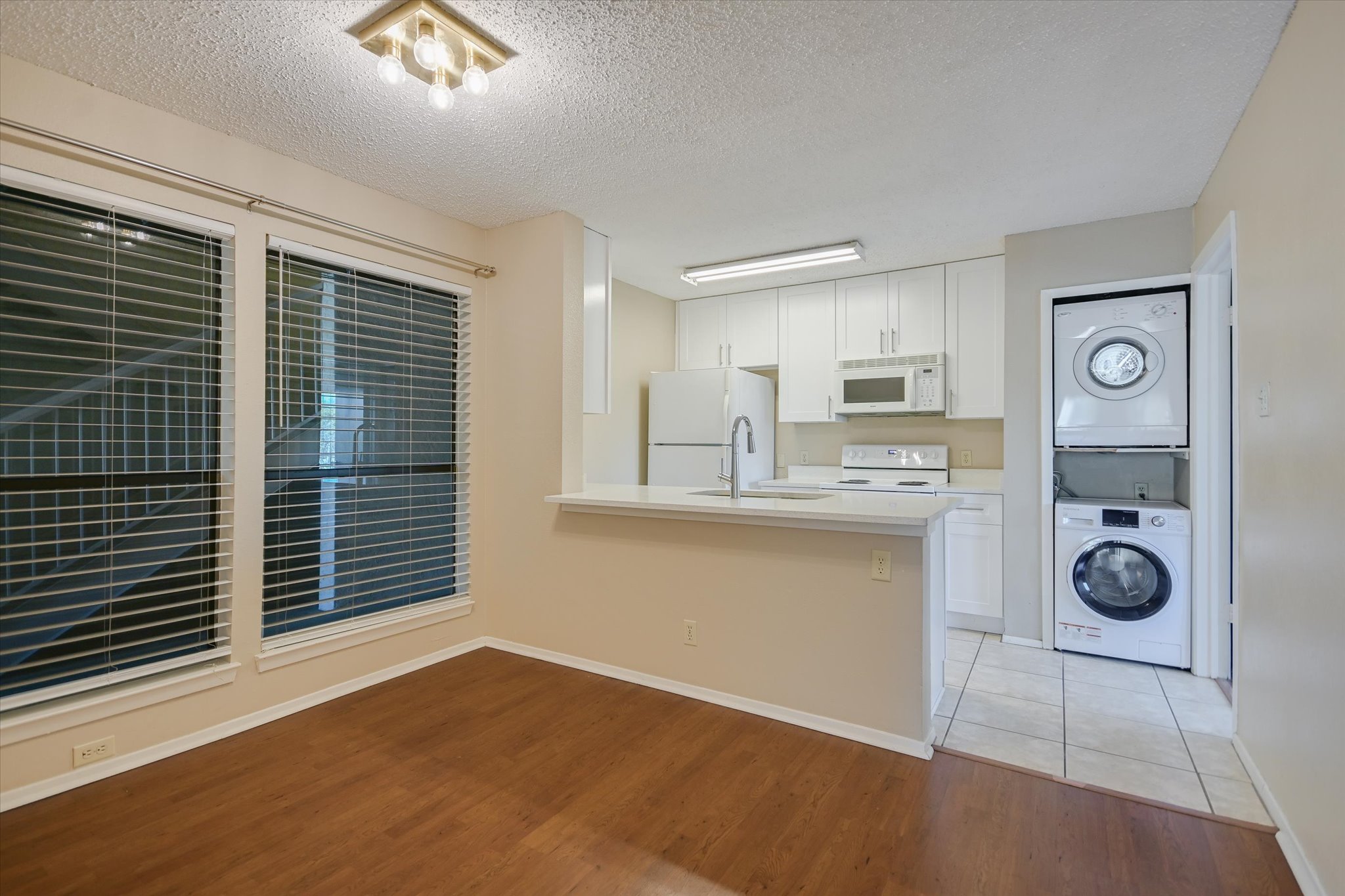 3115 Helms Street, Unit 112 Austin, TX 78705 - Photo 6 of 13 a kitchen with a refrigerator and a stove top oven