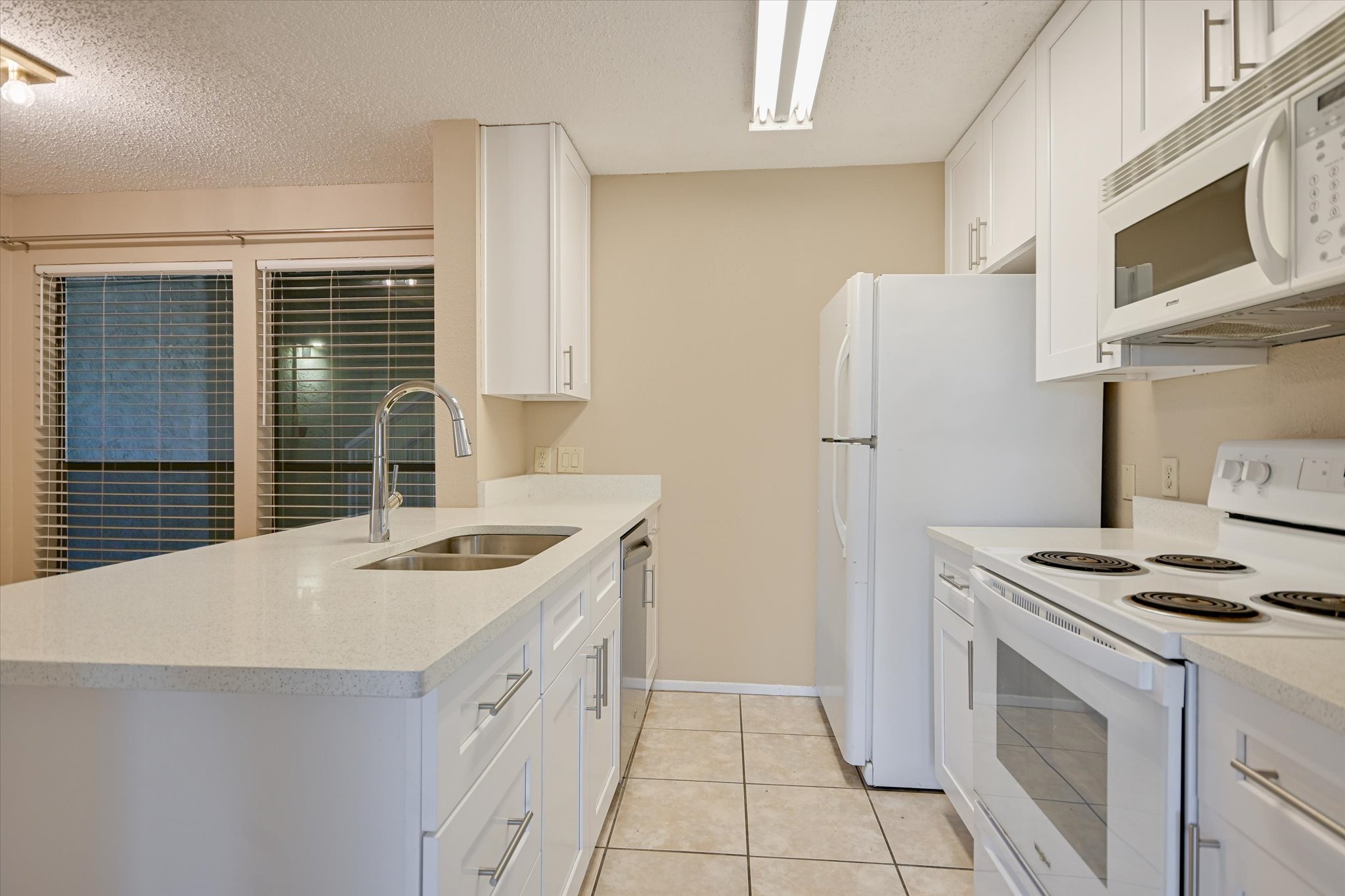 3115 Helms Street, Unit 112 Austin, TX 78705 - Photo 7 of 13 a kitchen with a sink stove and refrigerator
