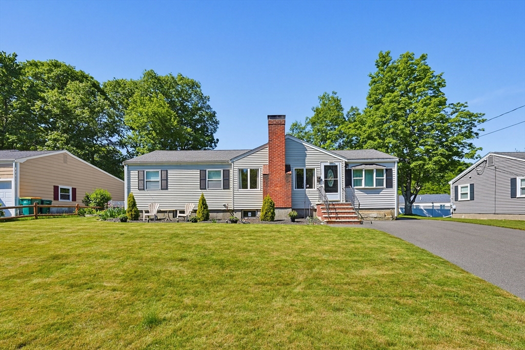 118 Spruce Road Norwood, MA 02062 - Photo 22 of 39 a front view of a house with a garden and trees