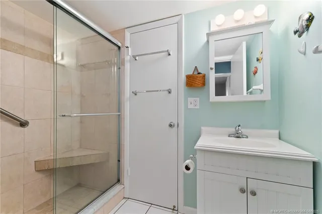 a bathroom with a shower sink and mirror