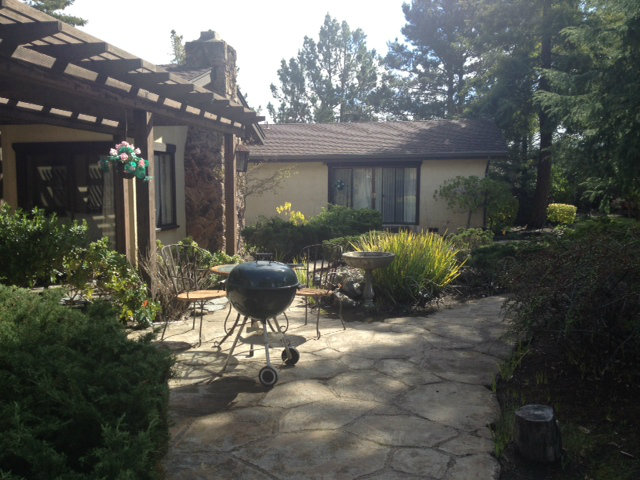 351 Ridgeway Road Woodside, CA 94062 - Photo 5 of 19 a view of a patio with table and chairs potted plants and large tree