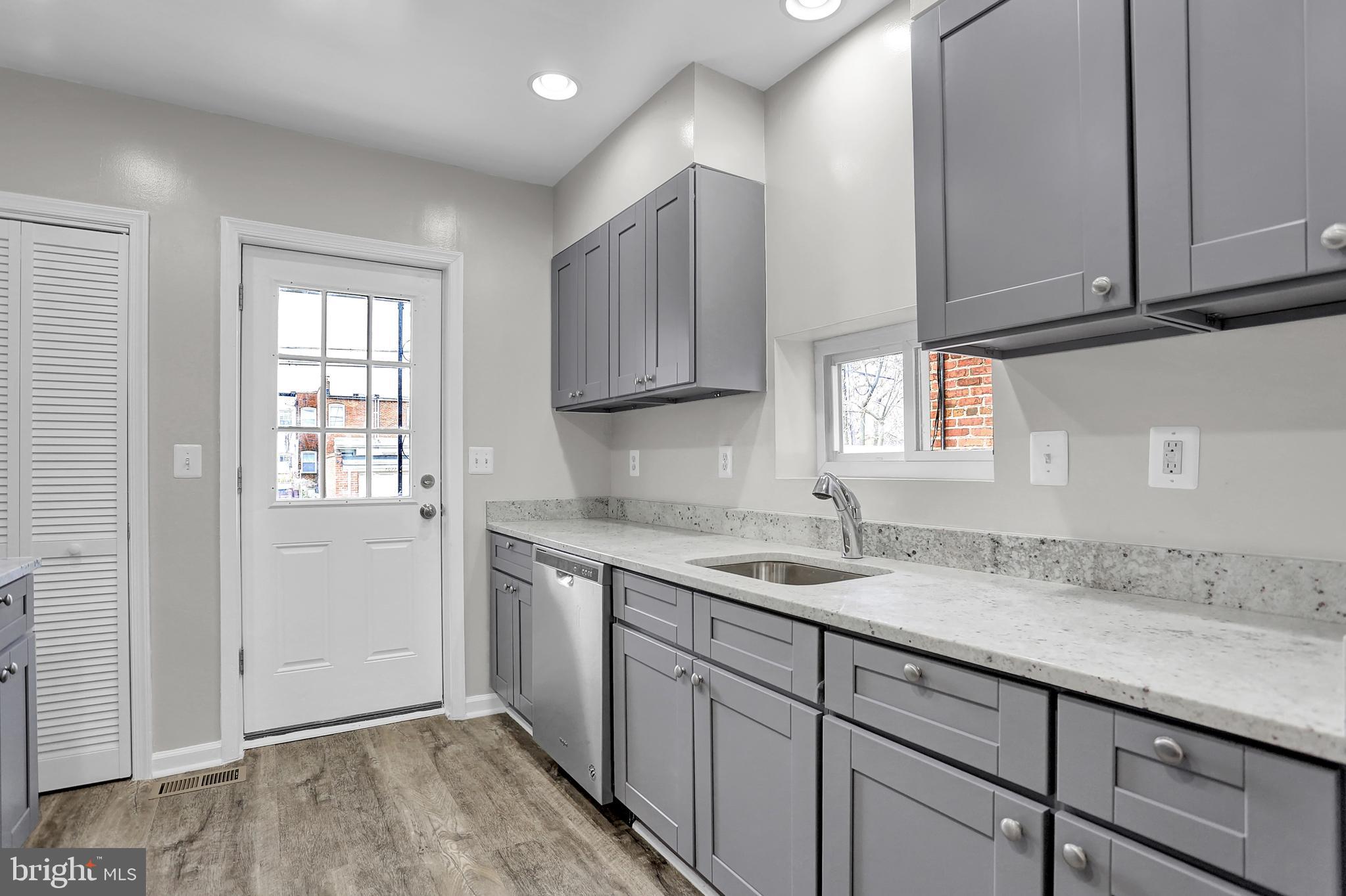 7025 Dunbar Road Dundalk, MD 21222 - Photo 13 of 27 a kitchen with a sink cabinets and window