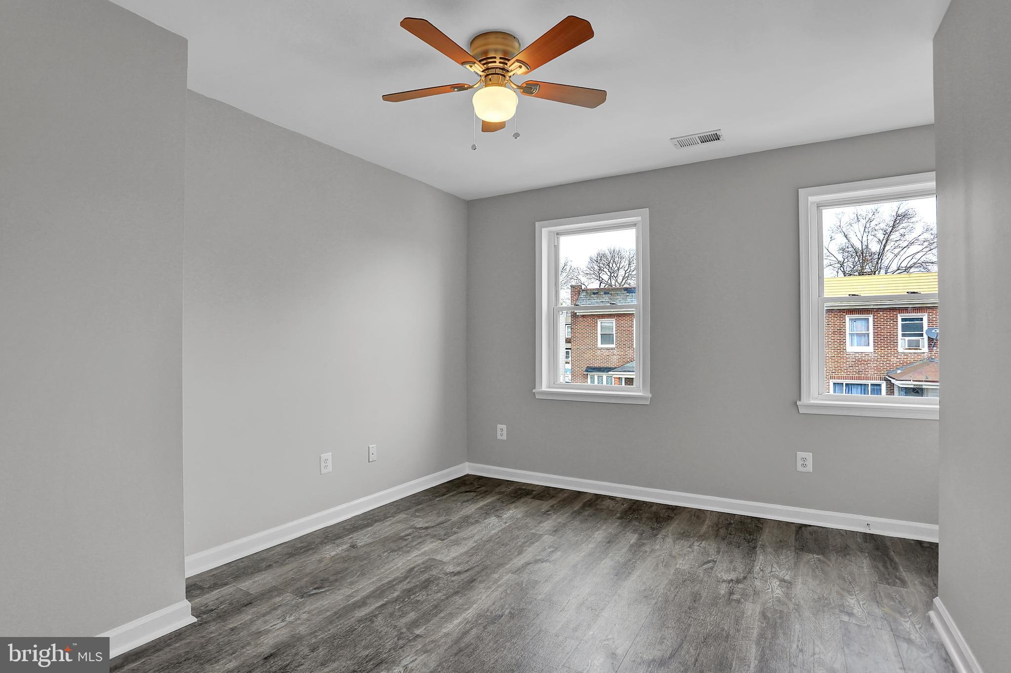 7025 Dunbar Road Dundalk, MD 21222 - Photo 16 of 27 a view of an empty room with window and wooden floor