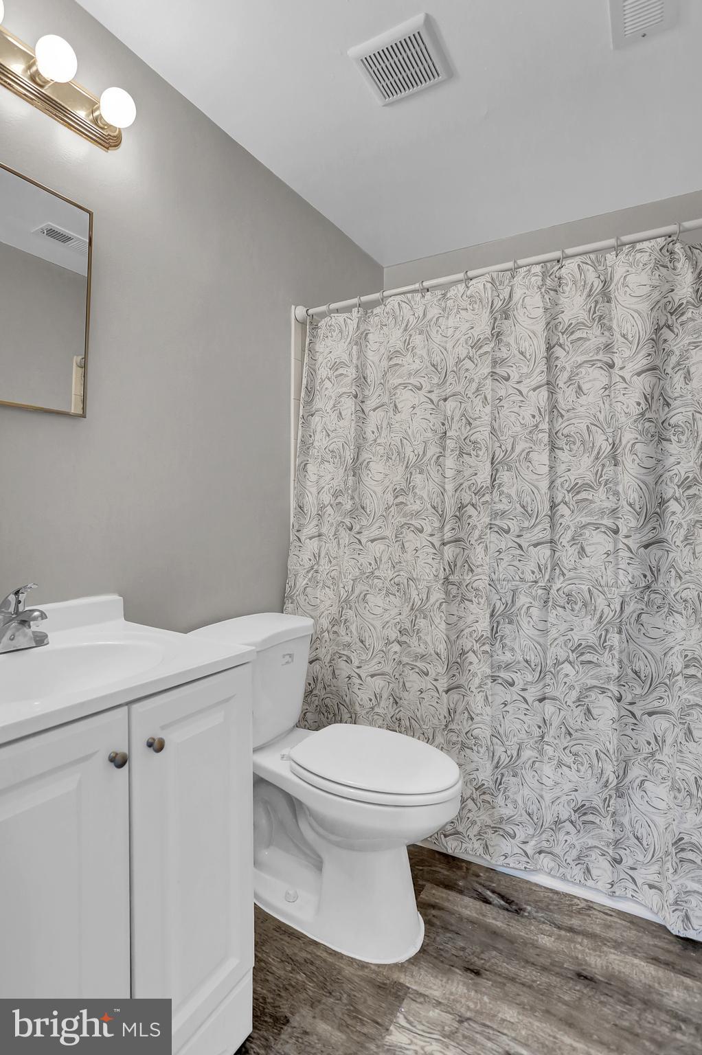 7025 Dunbar Road Dundalk, MD 21222 - Photo 19 of 27 a white toilet sitting next to a bathroom sink