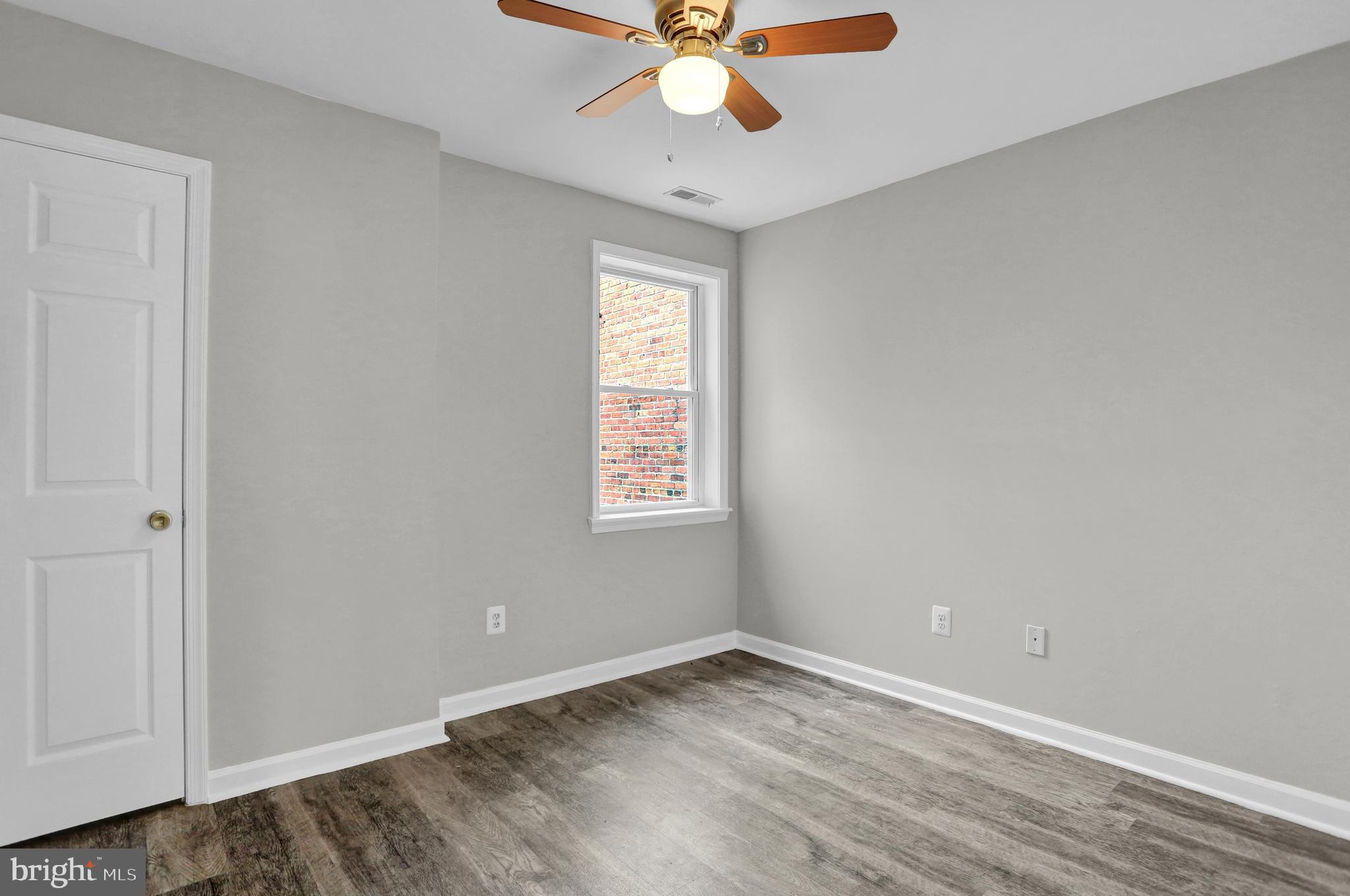 7025 Dunbar Road Dundalk, MD 21222 - Photo 20 of 27 an empty room with a window and a ceiling fan