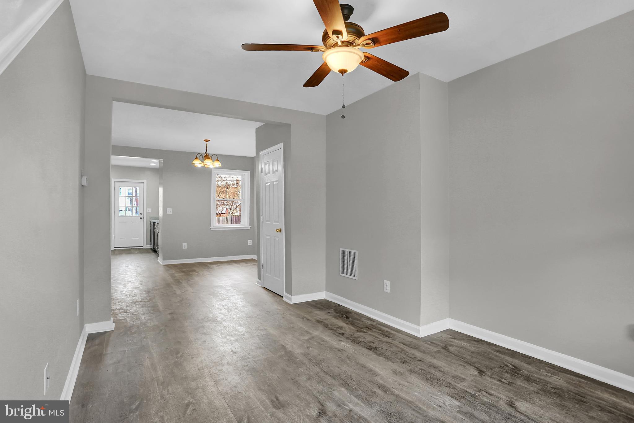 7025 Dunbar Road Dundalk, MD 21222 - Photo 4 of 27 wooden floor in an empty room with a window