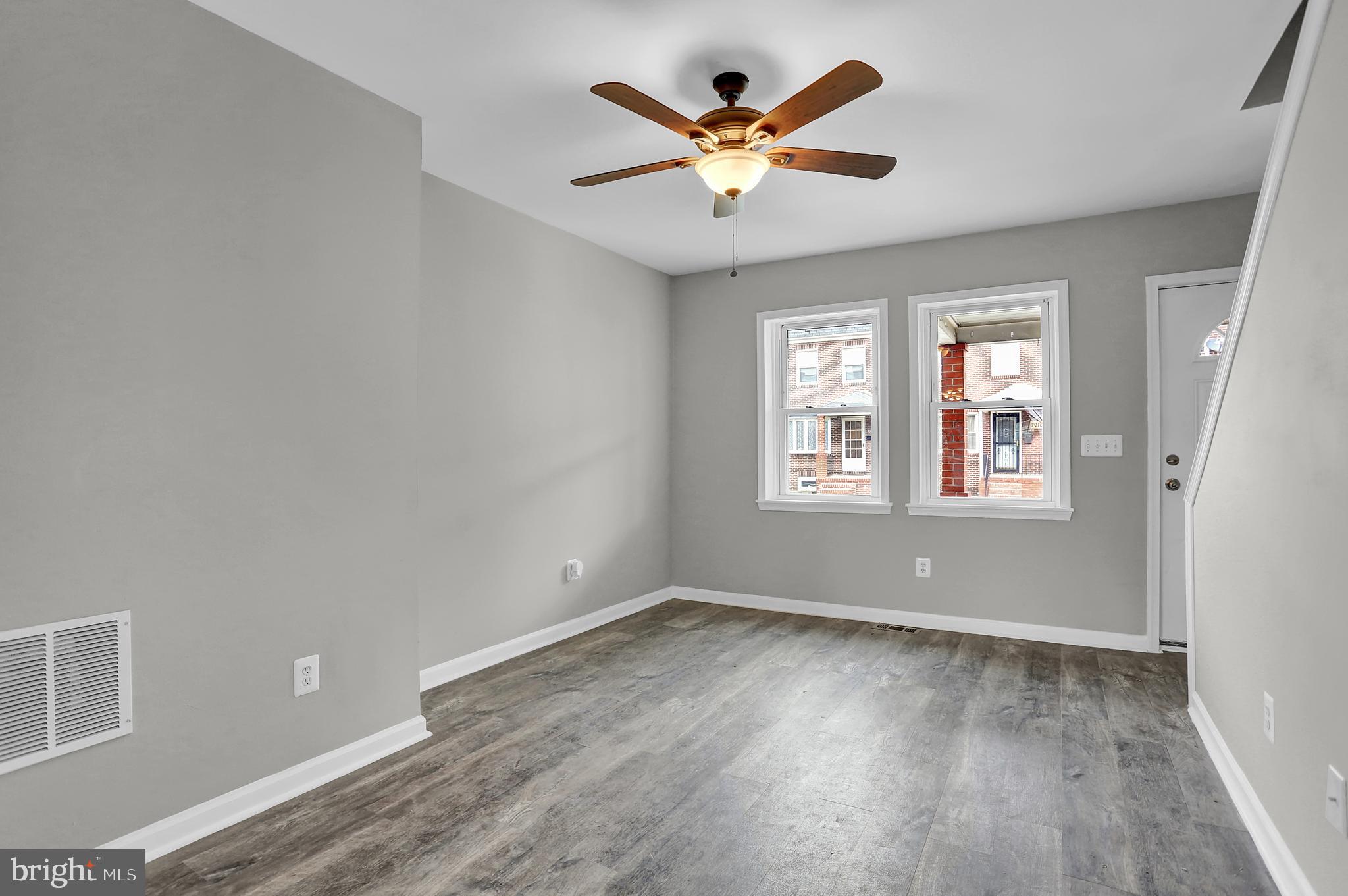 7025 Dunbar Road Dundalk, MD 21222 - Photo 7 of 27 an empty room with wooden floor and windows