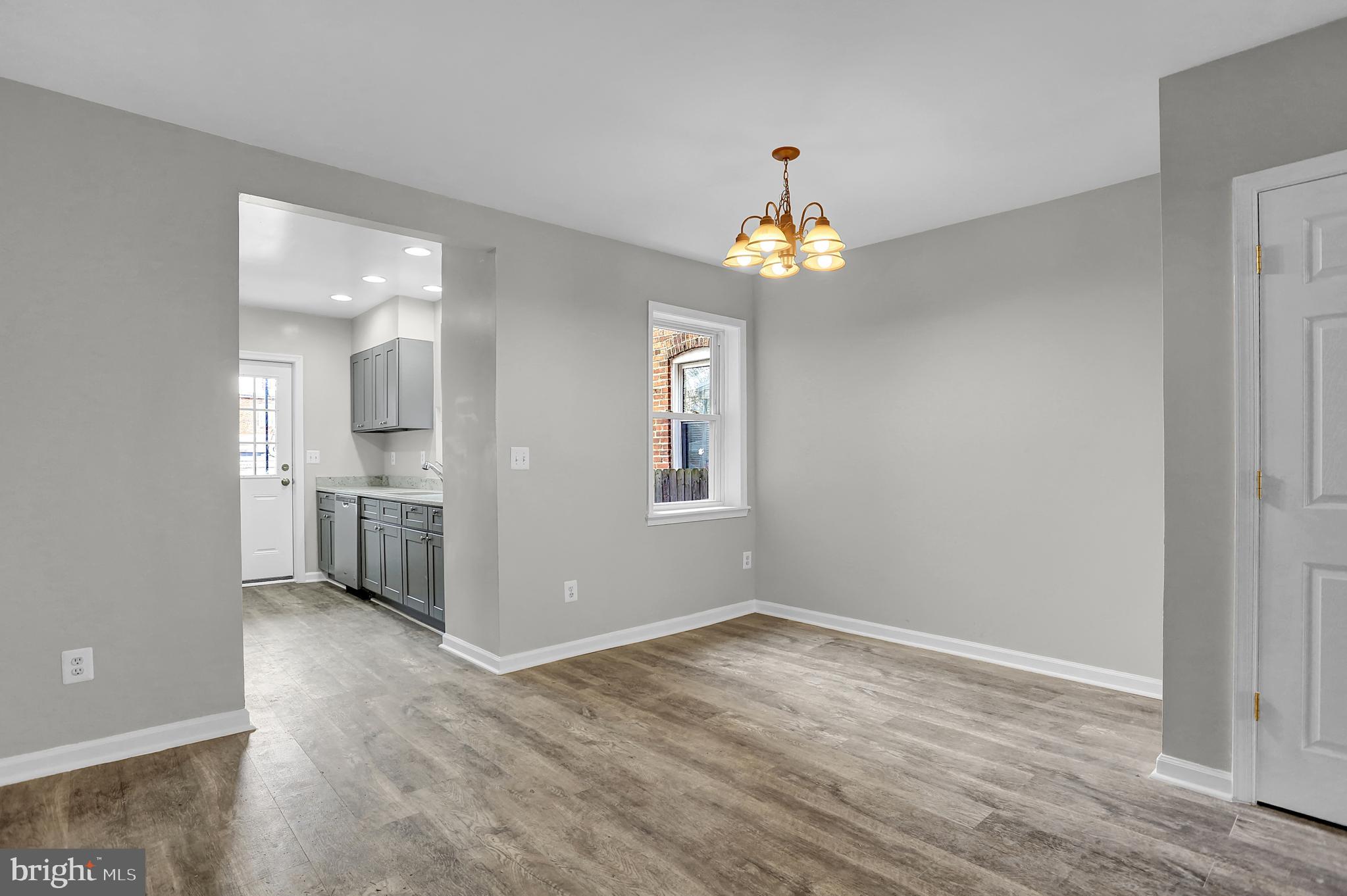 7025 Dunbar Road Dundalk, MD 21222 - Photo 8 of 27 wooden floor in an empty room with a window
