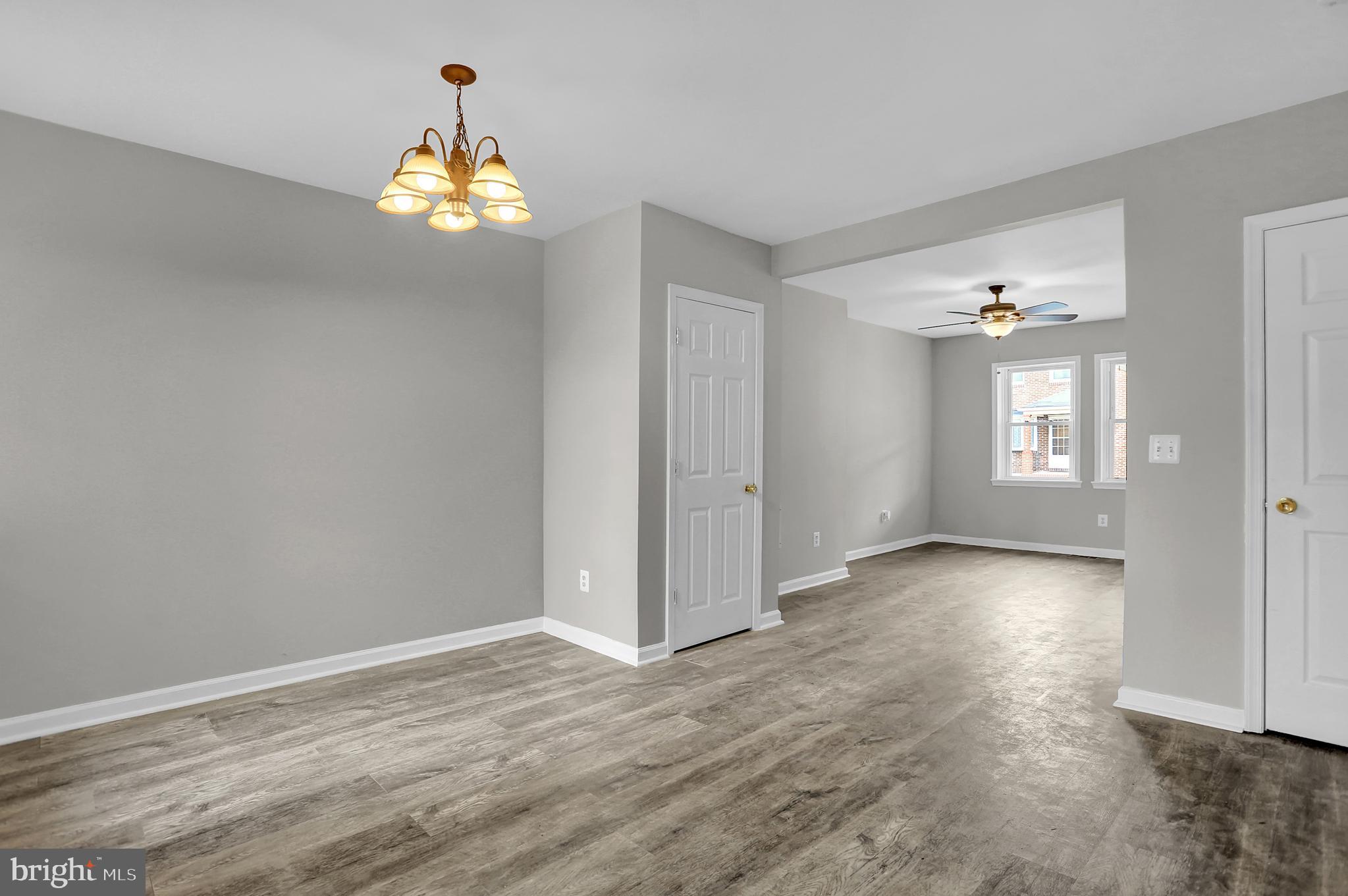 7025 Dunbar Road Dundalk, MD 21222 - Photo 9 of 27 a view of an empty room with window and wooden floor
