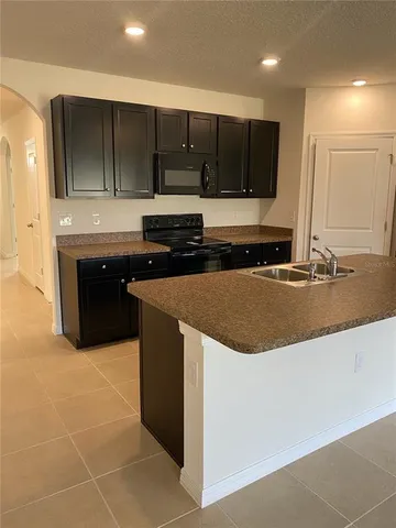 a kitchen with stainless steel appliances granite countertop a sink and a stove