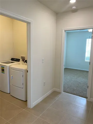 a view of storage and utility room with washer and dryer