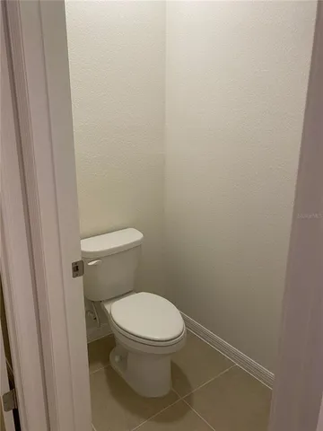 a white toilet sitting next to a shower