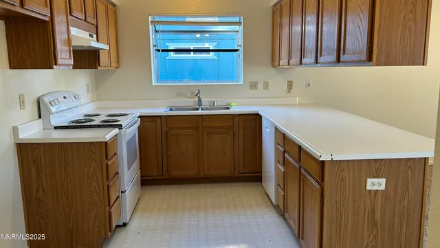 a kitchen with a sink cabinets and window