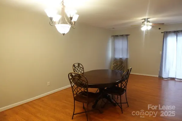 a view of a dining room with furniture and chandelier