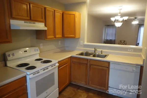 a kitchen with a sink cabinets and appliances