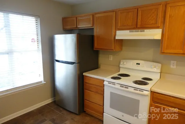 a kitchen with a refrigerator stove and cabinets