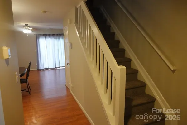 a view of entryway and hall with wooden floor
