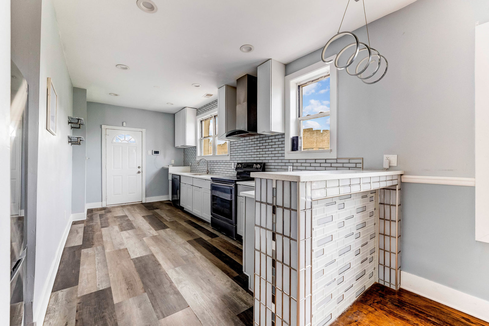 7759 South Constance Avenue Chicago, IL 60649 - Photo 11 of 26 a kitchen with stainless steel appliances granite countertop a sink stove and a refrigerator