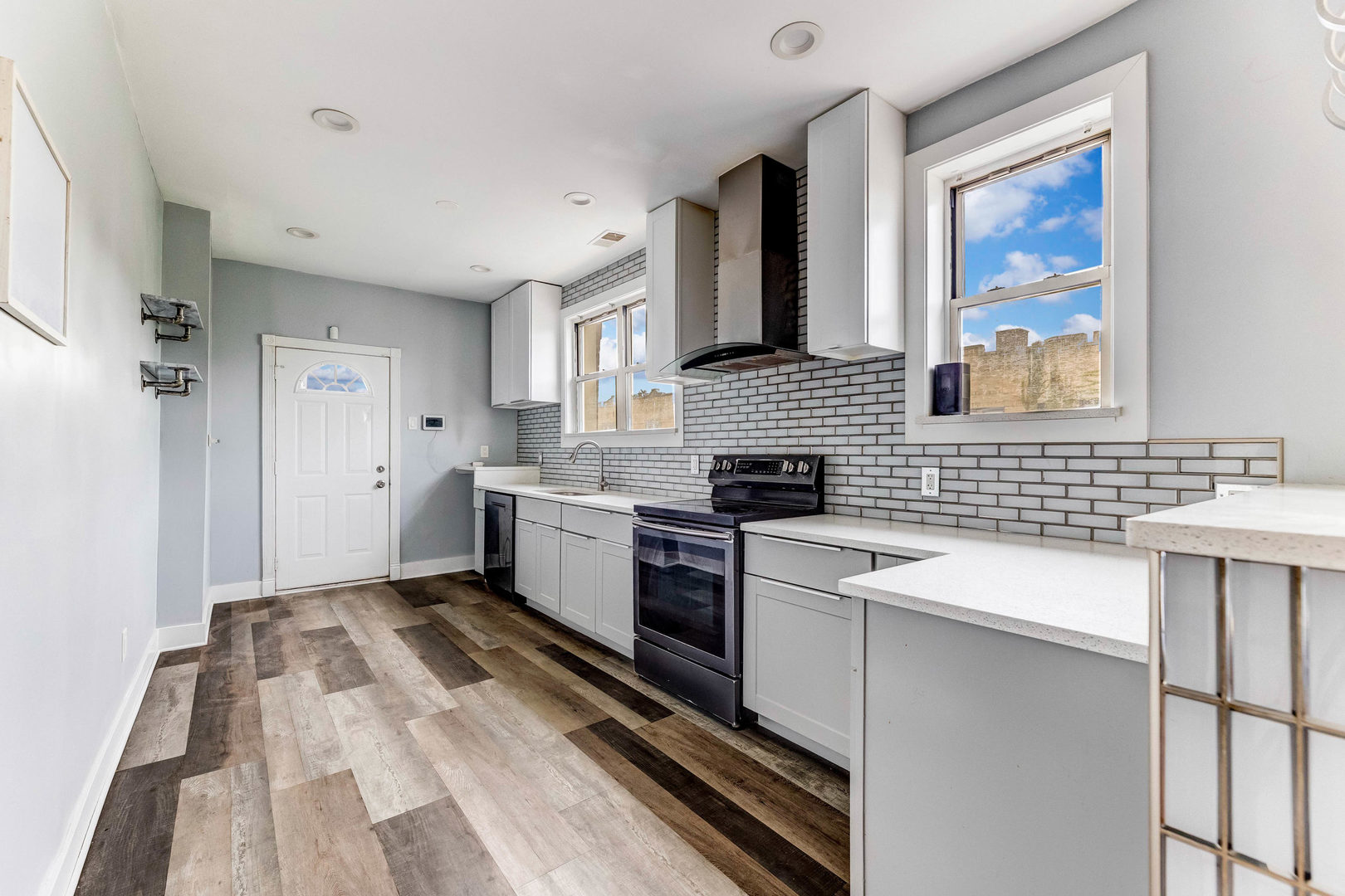 7759 South Constance Avenue Chicago, IL 60649 - Photo 12 of 26 a kitchen with a sink stove and cabinets