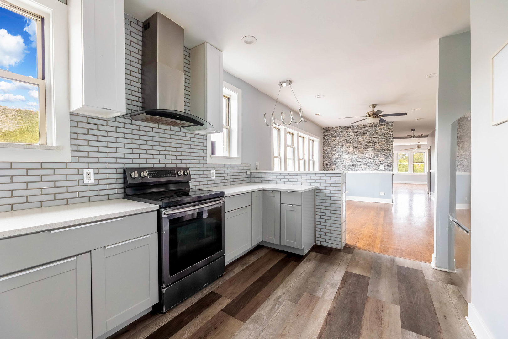 7759 South Constance Avenue Chicago, IL 60649 - Photo 15 of 26 a kitchen with a sink stove and cabinets