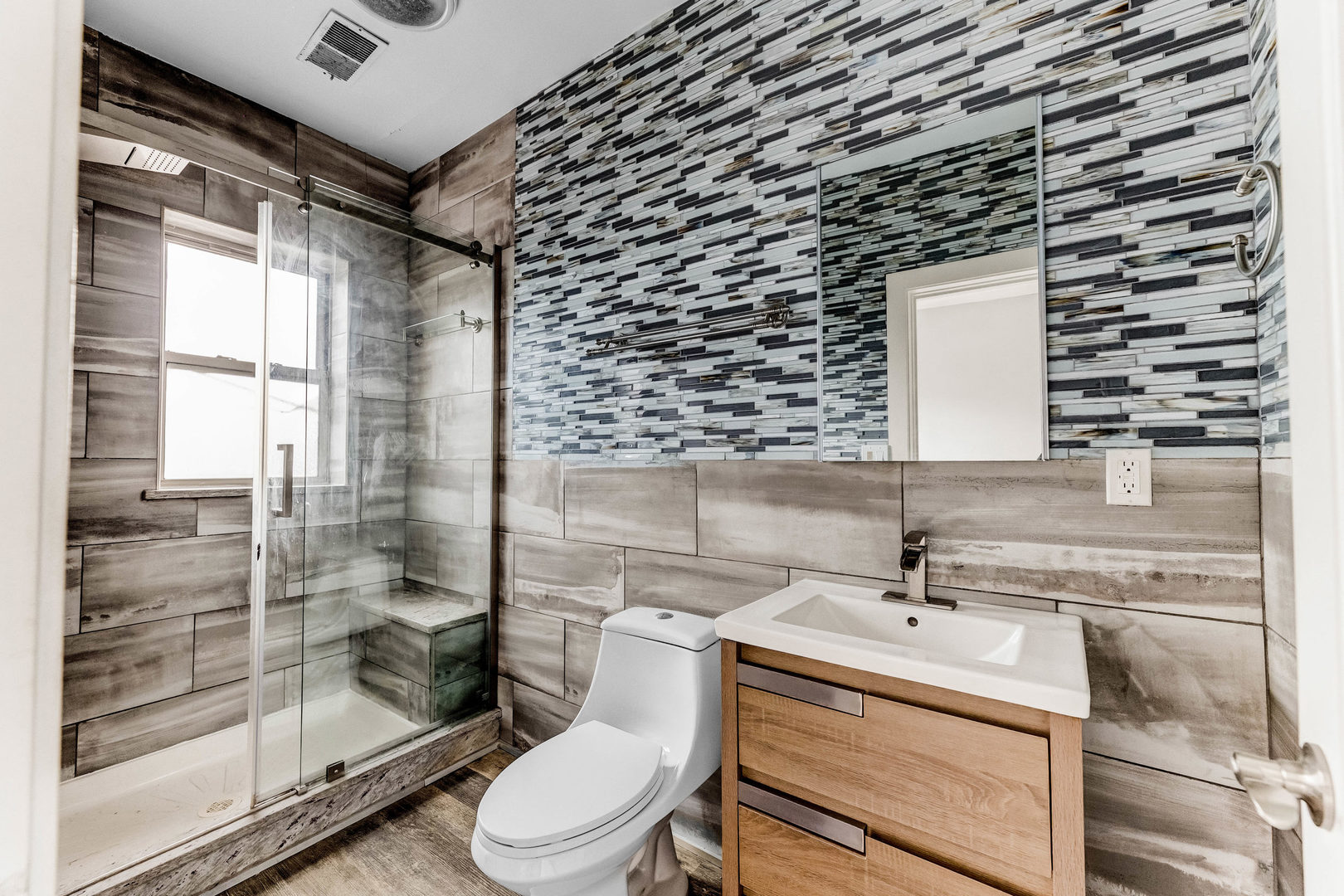 7759 South Constance Avenue Chicago, IL 60649 - Photo 24 of 26 a bathroom with a sink mirror vanity and toilet