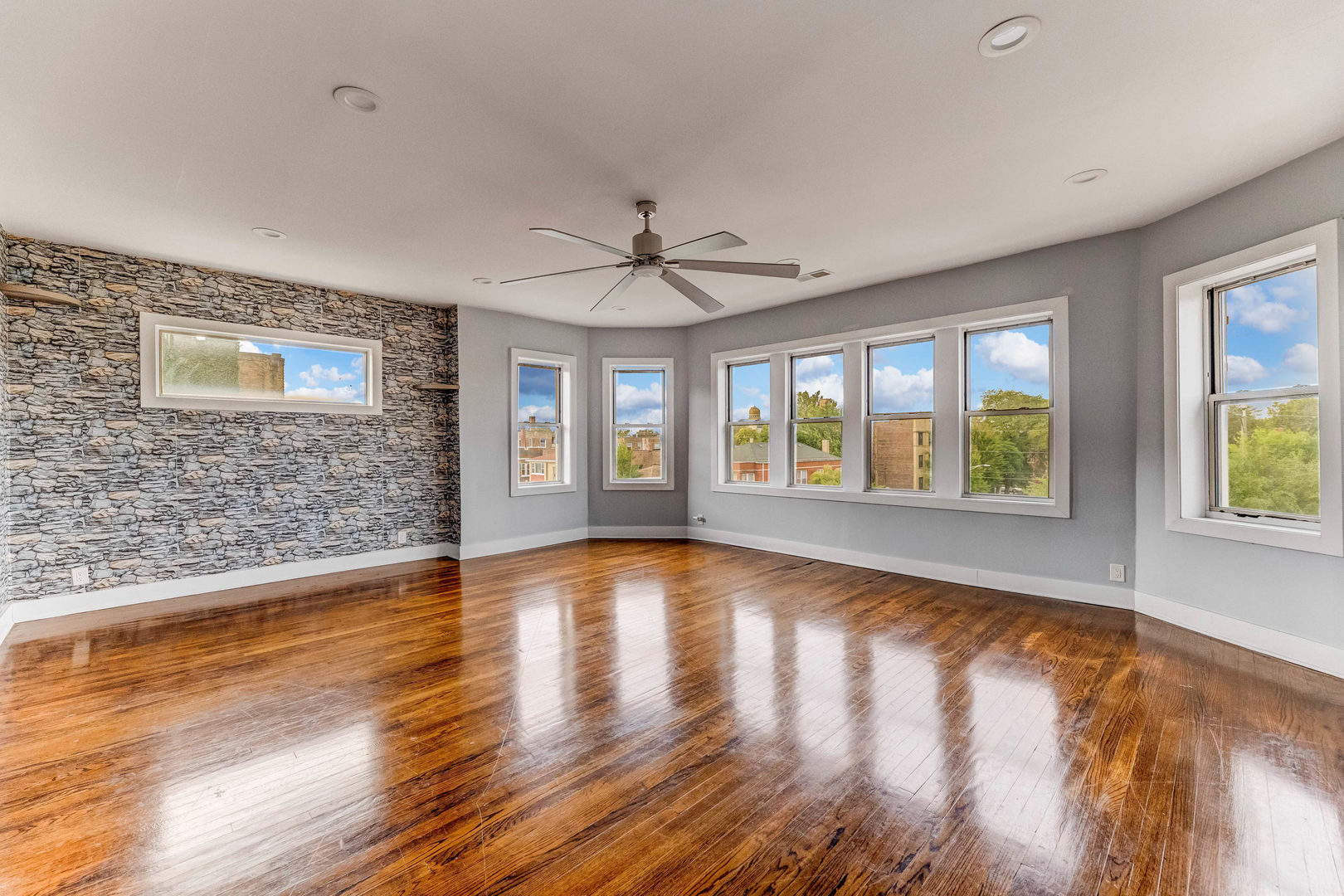 7759 South Constance Avenue Chicago, IL 60649 - Photo 3 of 26 a view of an empty room with window and wooden floor