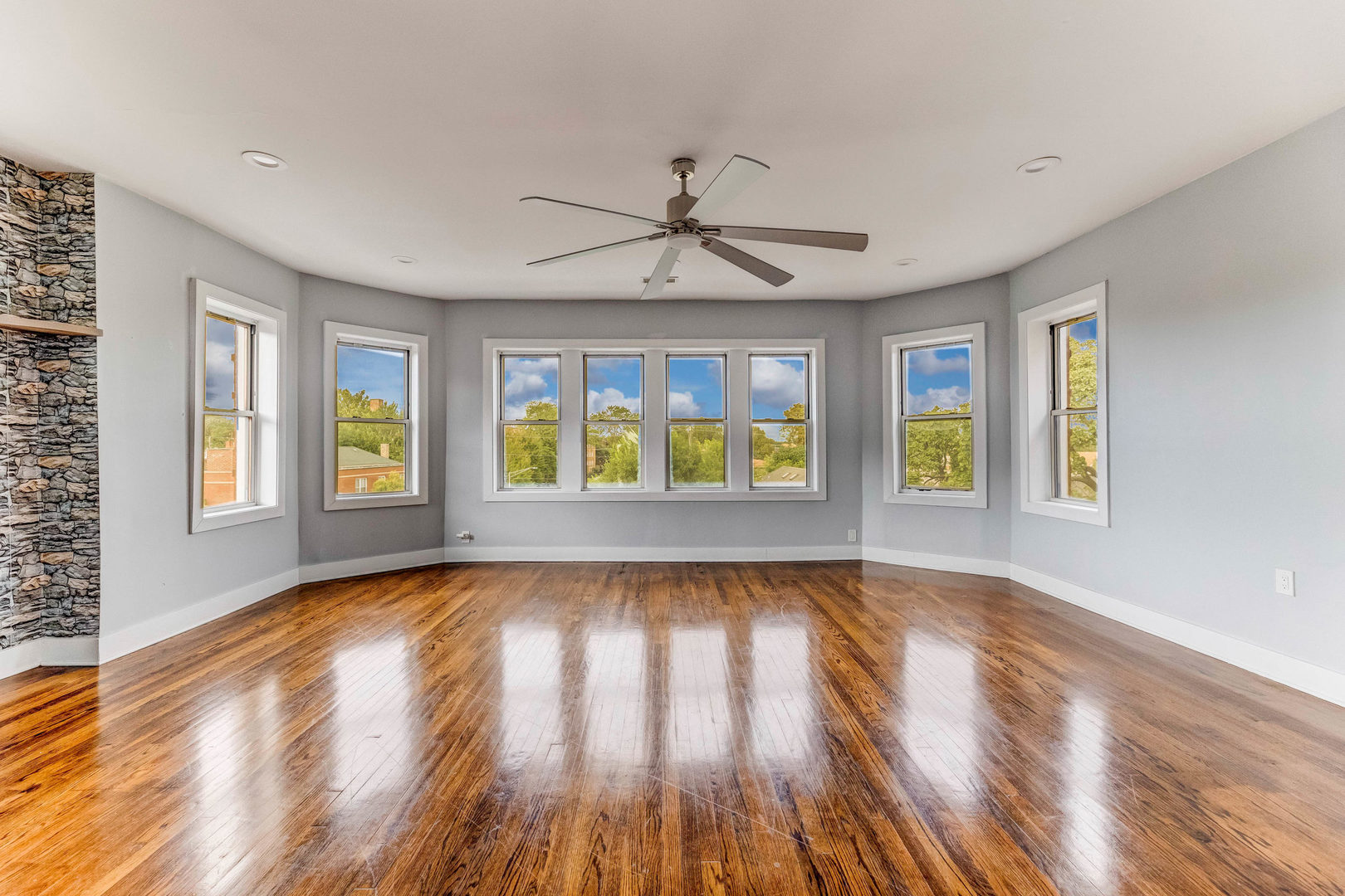7759 South Constance Avenue Chicago, IL 60649 - Photo 4 of 26 a view of an empty room with window and wooden floor